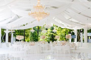 Festive wedding table setting with flowers, napkins, cutlery, glasses, bright summer table decor. Wedding decor