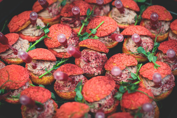 Catering table, beautifully decorated banquet with variety of with different food snacks and appetizers on corporate birthday party event or wedding celebration, seafood, canape, delicatessen setting