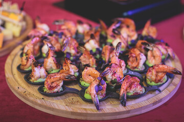 Catering table, beautifully decorated banquet with variety of with different food snacks and appetizers on corporate birthday party event or wedding celebration, seafood, canape, delicatessen setting