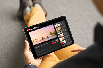 Man watching videos online on tablet - 422552311
