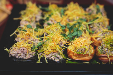 Catering table, beautifully decorated banquet with variety of with different food snacks and appetizers on corporate birthday party event or wedding celebration, seafood, canape, delicatessen setting