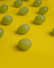 White Grapes on Yellow Background 