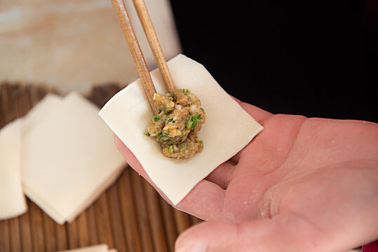 Chopsticks Sandwich The Meat Into The Dumpling Wrapper To Make Dumplings