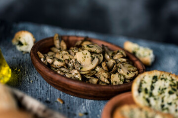 Fototapeta na wymiar fried mushrooms with garlic and parsley in a plate