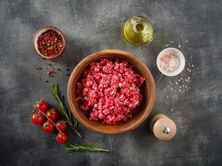 Fresh Raw mince, Minced beef, ground meat with herbs and spices in plate, top view.