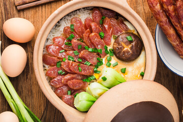 Cantonese style cooking of claypot rice with waxed meats