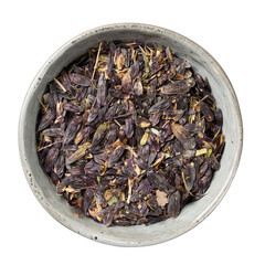 Bowl with seeds of woad (isatis tinctoria) isolated on white. Natural dye. Top view.