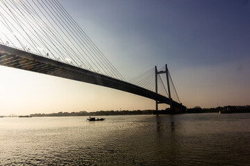 Silhouette of the iconic Howrah bridge over the Hooghly river in the city of Kolkata.