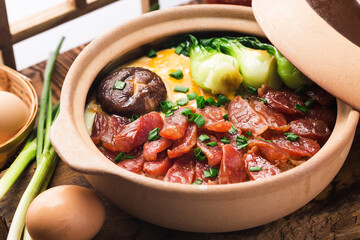 Cantonese style cooking of claypot rice with waxed meats