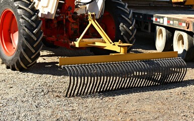 Tractor implement landscape rock rake attachment