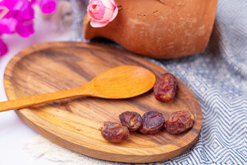 Dried dates on a wooden plate
