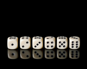 dice with reflection on black background, copy space