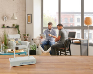 Modem and router box on the table and living room background blur concept.