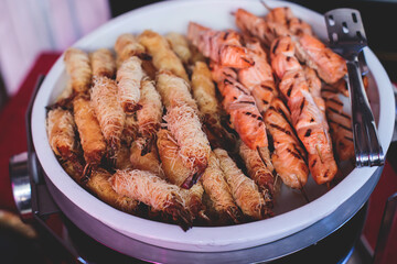 Catering table, beautifully decorated banquet with variety of with different food snacks and appetizers on corporate birthday party event or wedding celebration, seafood, canape, delicatessen setting