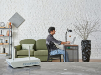 Modem and router box close up on the table style, decorative living room blue concept background.
