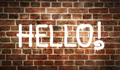 Hello sign spray painted on the brick wall