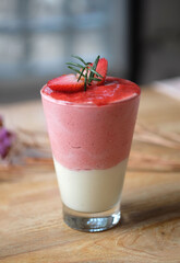 Strawberry yogurt smoothie with strawberries on wooden table. Healthy food for breakfast.