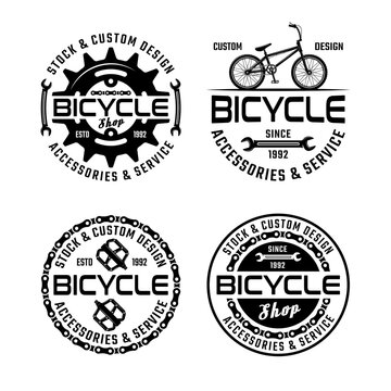 Bicycle shop and repair service set of four vector monochrome emblems, badges, labels or logos isolated on white background