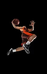 Fotobehang Young professional basketball player in action, motion isolated on black background, look from the bottom. Concept of sport, movement, energy and dynamic. © master1305