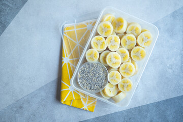 Delicious boiled banana served with black sesame mix sugar in box.