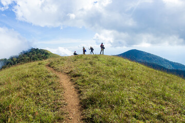 Obraz premium People or traveler walk on the Mountain hill with grass field with sea of fog or white clouds at 