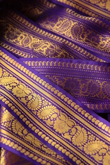 Purple violet Indian Sari border with gold paisley pattern. purple background
