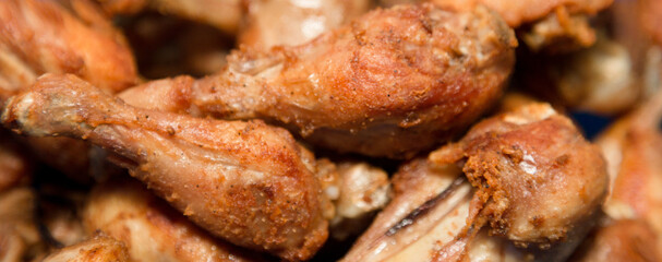 Fried chicken, drumstick and bedo with spices. Close-up