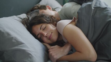 Romantic Caucasian couple embracing and sleeping together on bed in the morning at home - Powered by Adobe