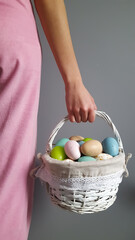 Colored easter eggs in a white basket. High quality photo