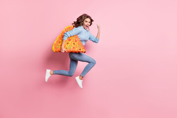 Photo of lady jump run fast open mouth hold pizza slice pinata wear blue pullover jeans footwear isolated pink background