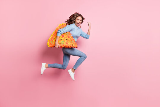 Photo Of Lady Jump Run Fast Open Mouth Hold Pizza Slice Pinata Wear Blue Pullover Jeans Footwear Isolated Pink Background