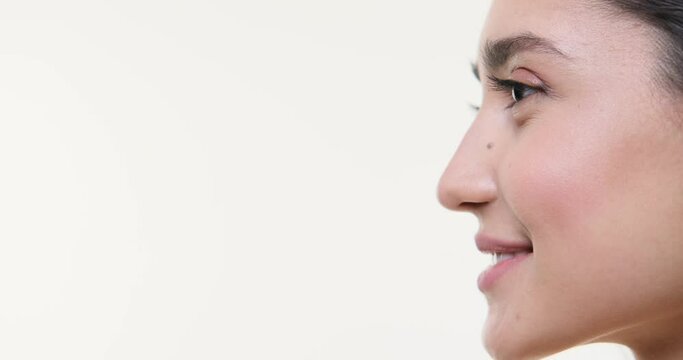 Side face of smiling woman over white background