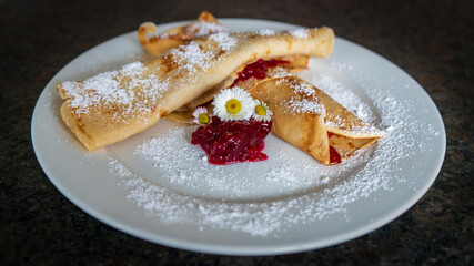 delicious pancakes with cranberries and powder sugar