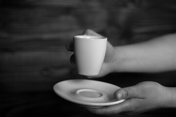 A coffee mug in female hands. Woman holding hot coffee. Black coffee, evening coffee. Vintage. Life style. 