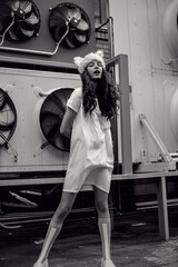 Monochrome urban teenager in white dress and fur hat