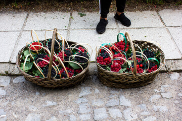 Above view of man selling baskets with wild berries