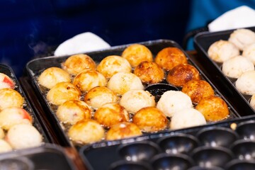 Close up of Takoyaki, octopus balls On Hot Pan, thai street food market