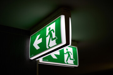 Emergency exit visible in the building.
