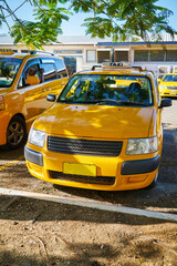 A parked yellow taxi in Fiji.

