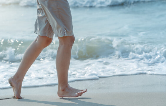 Beautiful healthy female legs jogging with barefoot alone on clean sandy sea beach in ocean in summer morning sunlight. Cute sports woman's legs. Copy space for text. Vacation and lifestyle concept - Powered by Adobe