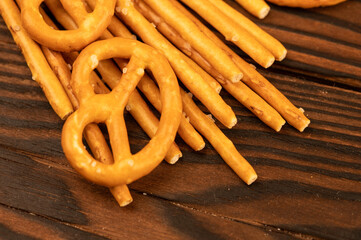 Salted breadsticks and salted pretzels scattered on the table.
