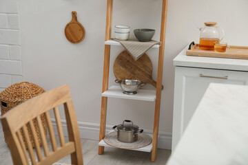 Fototapeta na wymiar Stylish kitchen room interior with wooden ladder near white wall