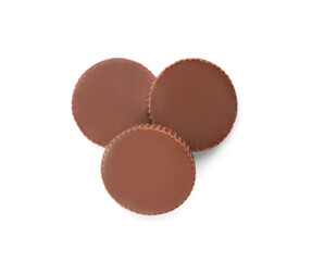 Delicious peanut butter cups on white background, top view