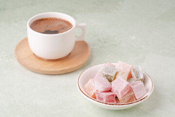 cup of coffee and Turkish delights on a green table