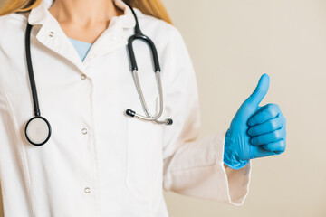 Image of female doctor showing thumb up.