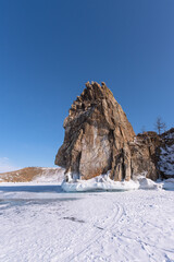 Fototapeta na wymiar Sacred Shamanka Mountain on Olkhon Island in winter. View from the frozen Lake Baikal in sunny day.