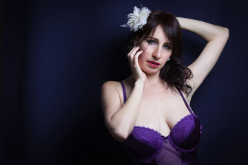 Naklejka premium Studio shot of sensual fashion model with violet corset