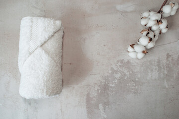 Boutique spa towel for a cosmetic beauty product shot against a luxury stone background. Organic spa product with cotton.
