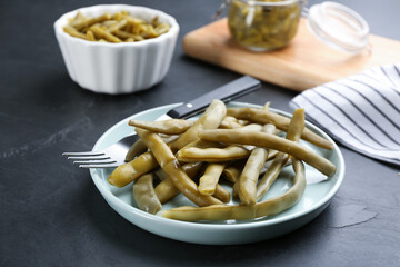 Delicious canned green beans served on black table