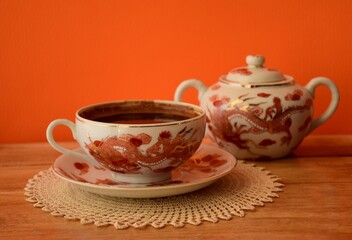 cup of coffee and miklpot on table